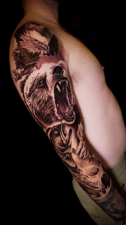 Black and grey realism roaring bear tattoo on an upper arm