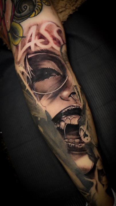 Black and grey realism portrait sleeve on a forearm