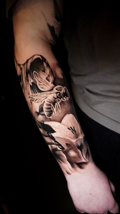 Black and grey realism tattoo on an inner forearm