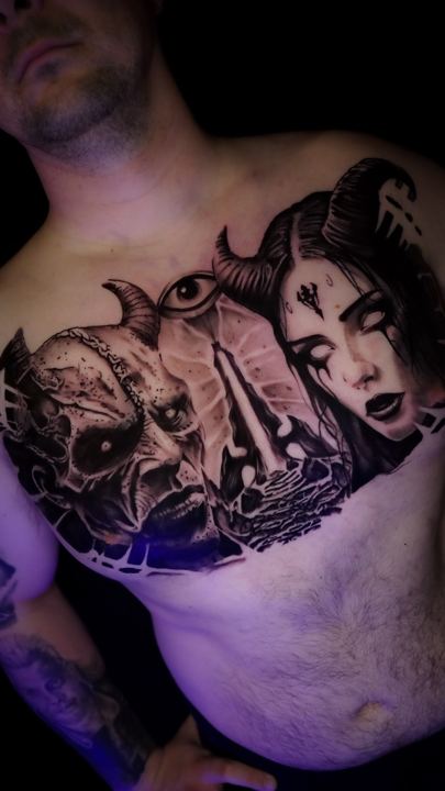 Black and grey realism chest piece with skulls and a portrait
