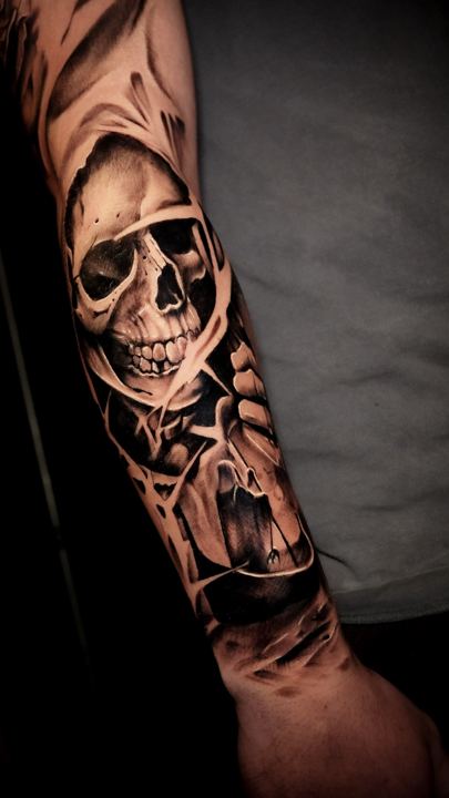 Black and grey realism skull tattoo on a forearm