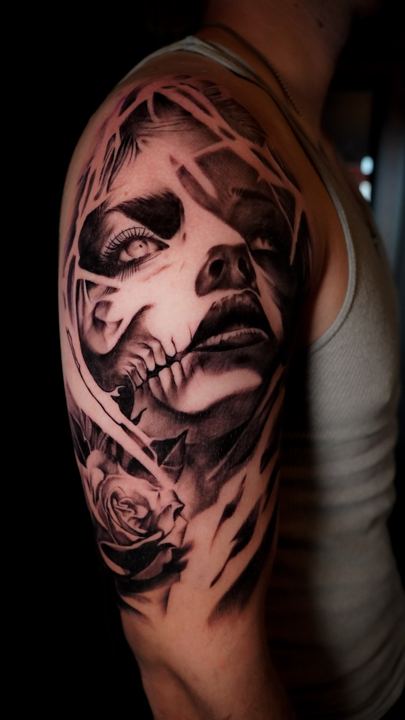 Black and grey realism portrait of a woman on a shoulder