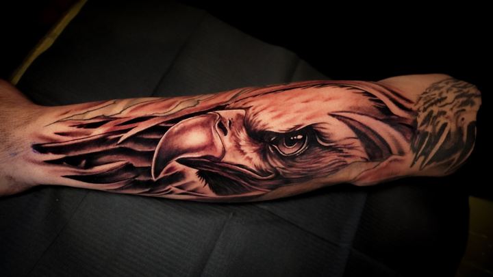 Black and grey realism eagle tattoo on a forearm