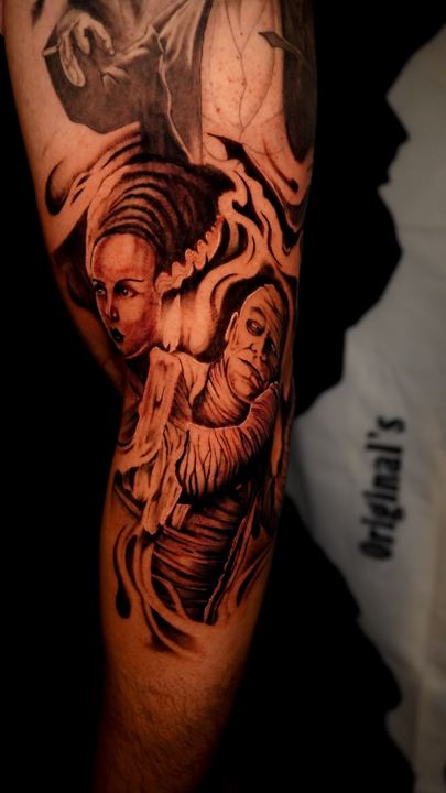 Black and grey realism classic horror monsters tattoo on an arm