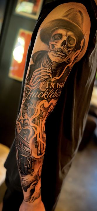 Black and grey realism western sleeve with a skeleton cowboy
