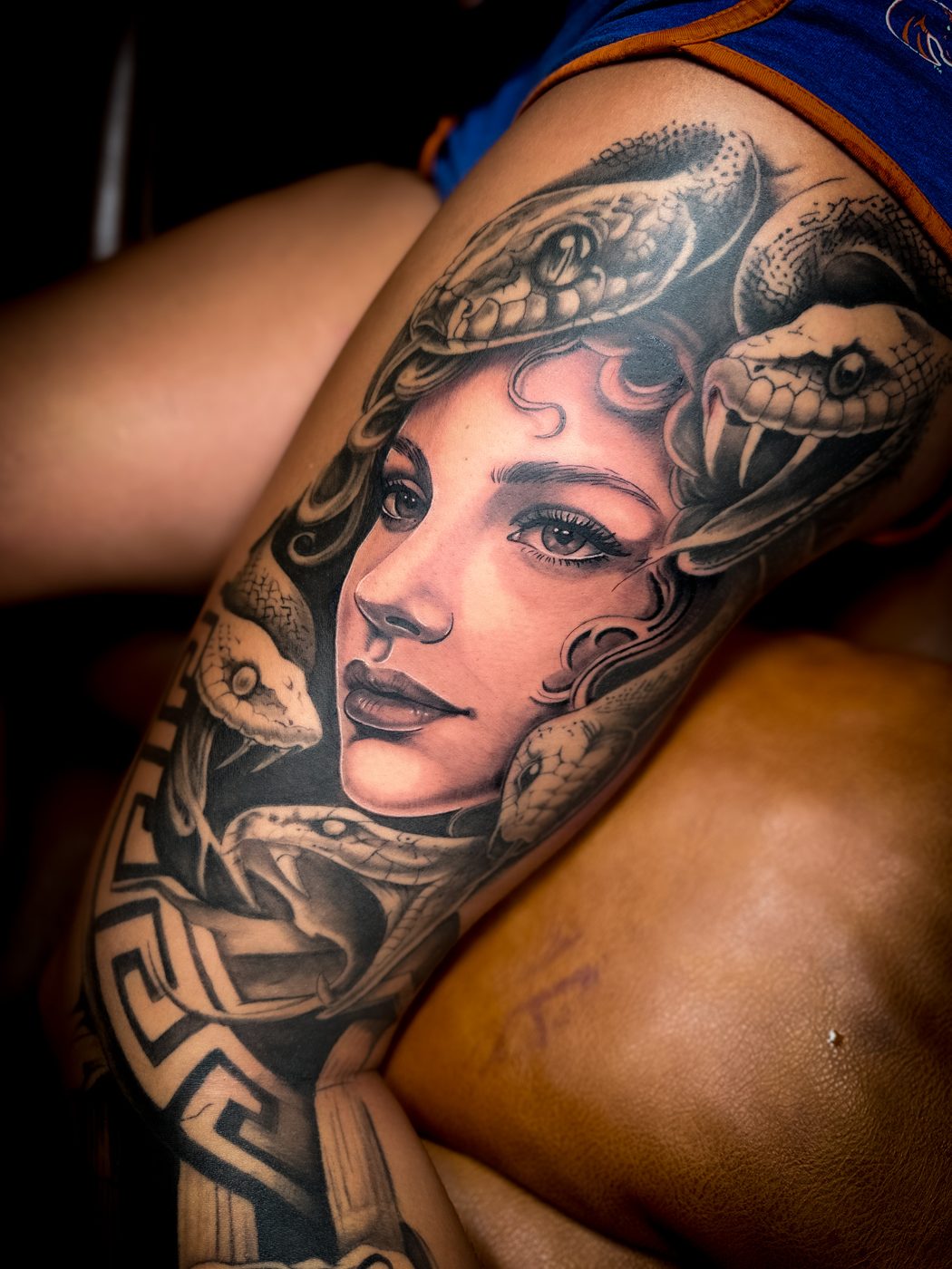 Black and grey realism Medusa portrait tattoo, close up